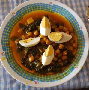 Plato hondo con potaje de garbanzos y espinacas tradicional de Semana Santa